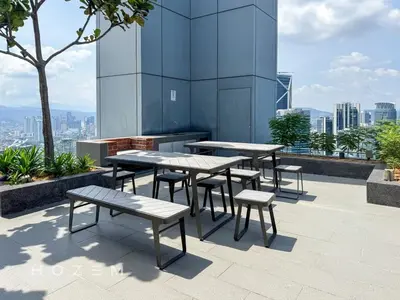 a group of tables and benches on top of a building at 2BR2B Hozem KL3802 Apartment KLCC in Kuala Lumpur