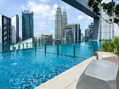 a swimming pool on the roof of a building with a city skyline at 2BR2B Hozem KL4207 Apartment KLCC in Kuala Lumpur
