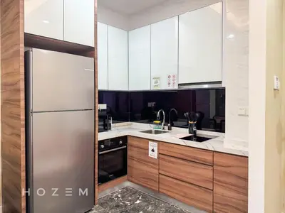 a kitchen with white cabinets and a stainless steel refrigerator at 2BR2B Hozem KL4207 Apartment KLCC in Kuala Lumpur