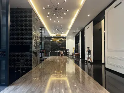 a lobby with a wooden floor and a large ceiling at Chambers Residence by Fancy House in Kuala Lumpur