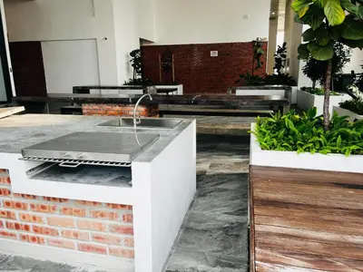a kitchen with a sink in a room with plants at Chambers Residence by Fancy House in Kuala Lumpur