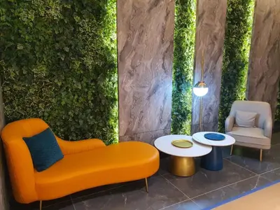 an orange couch and two chairs and a table at Inspirasi Mont Kiara Cozy Homestay with Pool View Kuala Lumpur in Kuala Lumpur