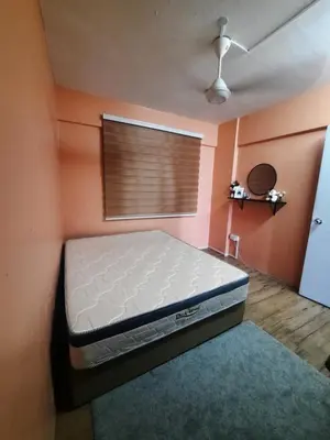 a bedroom with a bed in a room with a window at Homestay Lala in Kuala Lumpur