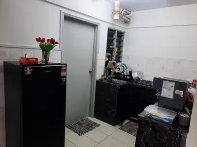 a kitchen with a black refrigerator and a door at Homestay Lala in Kuala Lumpur