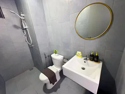 a bathroom with a sink and a toilet and a mirror at M Vertica Residence by Dynasty in Kuala Lumpur