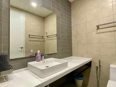a bathroom with a white sink and a mirror at The Loft Living Suites at Robertson Residences in Kuala Lumpur
