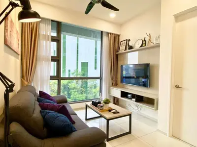 a living room with a couch and a tv at The Loft Living Suites at Robertson Residences in Kuala Lumpur