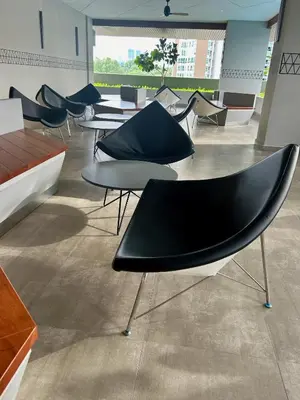 a group of tables and chairs in a room at KL Central 32 Floor KLCC View in Kuala Lumpur
