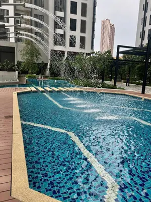 a swimming pool with a fountain in a city at KL Central 32 Floor KLCC View in Kuala Lumpur