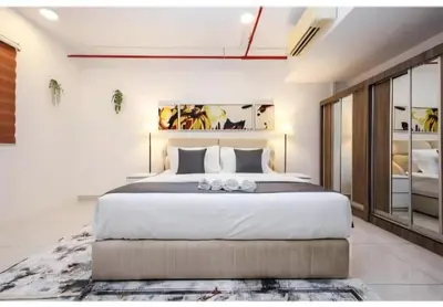 a bedroom with a large bed with white sheets at Bmc Homez Suite 3towers in Kuala Lumpur