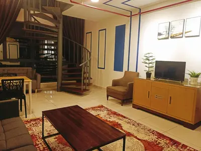 a living room with a tv and a couch and a table at Bmc Homez Suite 3towers in Kuala Lumpur