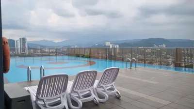 a group of chairs sitting next to a swimming pool at Bmc Homez Suite 3towers in Kuala Lumpur