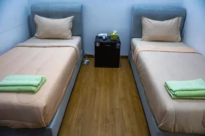 two beds sitting next to each other in a room at Entire Apartment in Kuala Lumpur, Infinity Pool!! in Kuala Lumpur