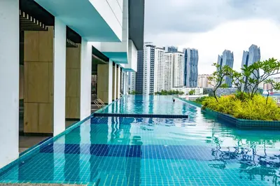 a swimming pool in a building with a city skyline at Entire Apartment in Kuala Lumpur, Infinity Pool!! in Kuala Lumpur