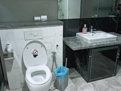 a bathroom with a white toilet and a sink at KLCC Sky villa Suites Platinum by MiM in Kuala Lumpur