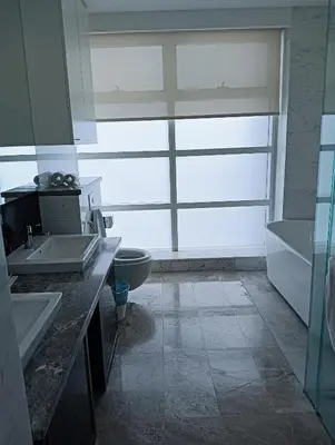 a bathroom with two sinks and a toilet and a window at KLCC Sky villa Suites Platinum by MiM in Kuala Lumpur