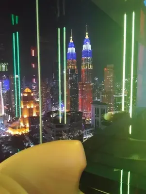 a view of a city skyline at night at KLCC Sky villa Suites Platinum by MiM in Kuala Lumpur