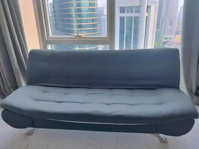 a couch in a room with a large window at KLCC Sky villa Suites Platinum by MiM in Kuala Lumpur