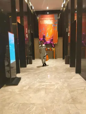 a person walking down a hallway in a building at KLCC Sky villa Suites Platinum by MiM in Kuala Lumpur