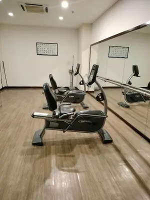 a gym with three exercise bikes in a room at Global suites at time square KL in Kuala Lumpur