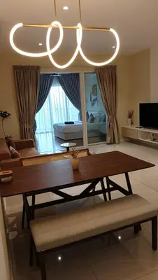a living room with a table and a chandelier at Quill Residence- City View Condo by Azmila in Kuala Lumpur