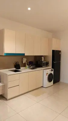 a kitchen with a refrigerator and a washing machine at Quill Residence- City View Condo by Azmila in Kuala Lumpur
