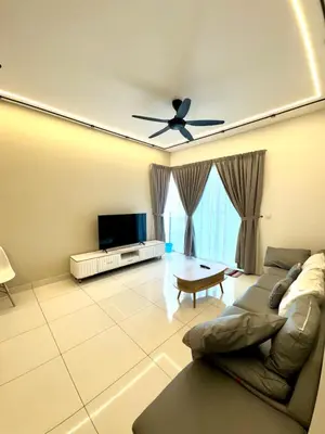 a living room with a couch and a ceiling fan at 3Room 5 Pax stay in Mont Kiara in Kuala Lumpur