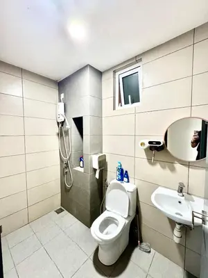 a bathroom with a shower and a toilet and a sink at 3Room 5 Pax stay in Mont Kiara in Kuala Lumpur