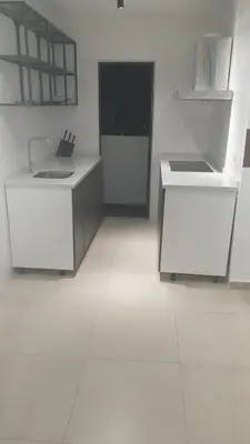 a kitchen with two white counters in a room at 10 Pax stay in Kl Area in Kuala Lumpur