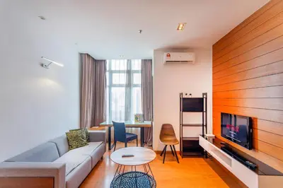 a living room with a couch and a tv and a table at Dua Sentral Kuala Lumpur near KL Sentral in Kuala Lumpur