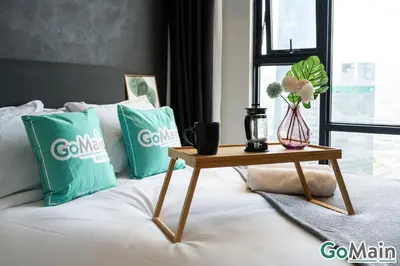 a bed with two pillows and a table with a coffee table at AXON BUKIT BINTANG w Skypool - Walk to Pavilion KLCC KL TRX in Kuala Lumpur