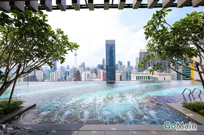 a swimming pool with a city skyline in the background at AXON BUKIT BINTANG w Skypool - Walk to Pavilion KLCC KL TRX in Kuala Lumpur