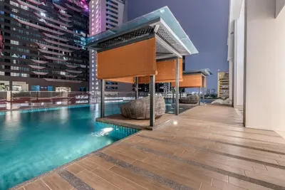 a swimming pool on the roof of a building at Cozy Stay in KLCC\u5409\u9686\u73bb in Kuala Lumpur
