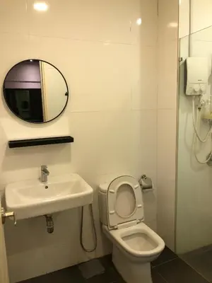 a bathroom with a sink and a toilet and a mirror at Cozy Stay in KLCC\u5409\u9686\u73bb in Kuala Lumpur