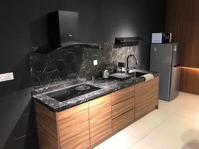 a kitchen with a sink and a refrigerator at Cozy Stay in KLCC\u5409\u9686\u73bb in Kuala Lumpur