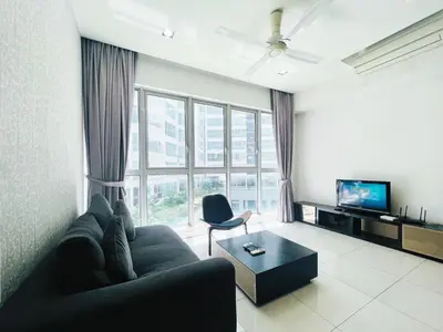 a living room with a couch and a large window at Regalia Residences And Suites By The Relaxstay in Kuala Lumpur