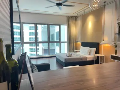 a hotel room with a bed and a large window at Regalia Residences And Suites By The Relaxstay in Kuala Lumpur