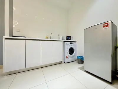 a kitchen with a refrigerator and a washing machine at Arte Plus Ampang By The Relaxstay in Kuala Lumpur