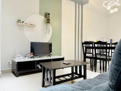 a living room with a tv and a table at Arte Plus Ampang By The Relaxstay in Kuala Lumpur