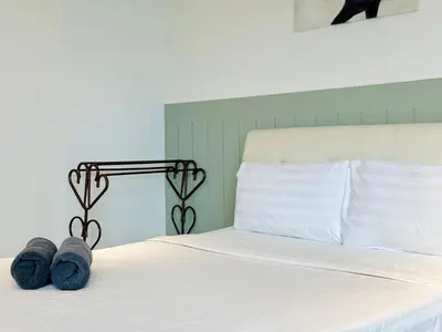 a bed with two pairs of shoes on it at Arte Plus Ampang By The Relaxstay in Kuala Lumpur