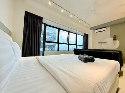 a bedroom with a large bed with a camera on it at Arte Plus Ampang By The Relaxstay in Kuala Lumpur
