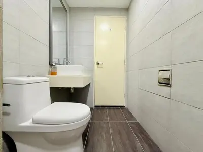 a bathroom with a white toilet and a sink at Arte Plus Ampang By The Relaxstay in Kuala Lumpur