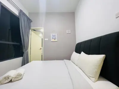 a bedroom with a white bed with two white pillows at Arte Plus Ampang By The Relaxstay in Kuala Lumpur