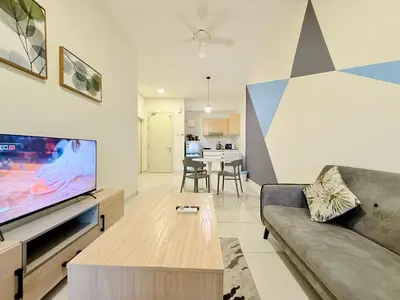a living room with a couch and a tv at Arte Mont Kiara By The Relaxstay in Kuala Lumpur
