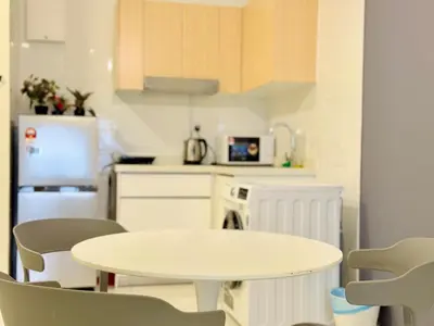 a kitchen with a white table and chairs at Arte Mont Kiara By The Relaxstay in Kuala Lumpur