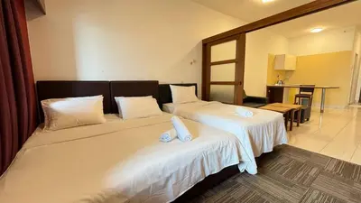 a hotel room with two beds with white sheets at Cempaka Apartment by Easy Nap in Kuala Lumpur