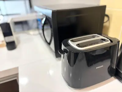 a toaster with a cell phone inside of it at Cempaka Apartment by Easy Nap in Kuala Lumpur