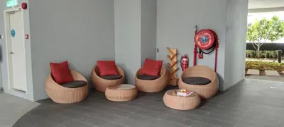 a group of chairs with red pillows in a room at KL Comfy Masterbedroom wt bathroom in Kuala Lumpur