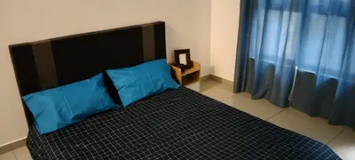 a bedroom with a bed with a blue pillow on it at KL Comfy Masterbedroom wt bathroom in Kuala Lumpur