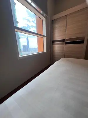 a bedroom with a large bed and a window at Sky Suite KLCC By near klcc in Kuala Lumpur